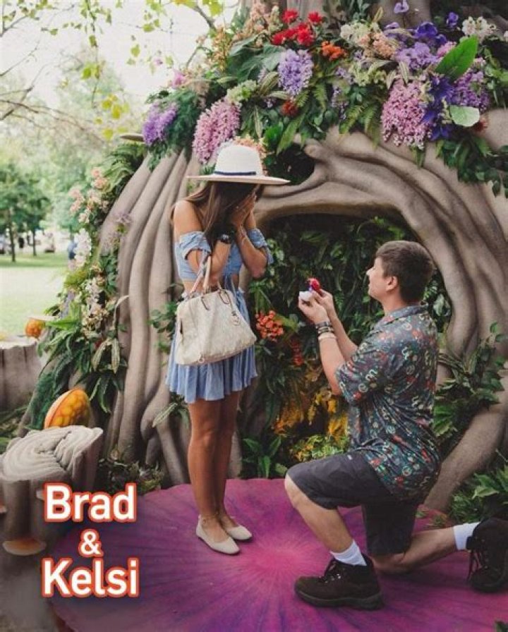 Brad and Kelsi posing at Pokémon GO Fest with her engagement ring