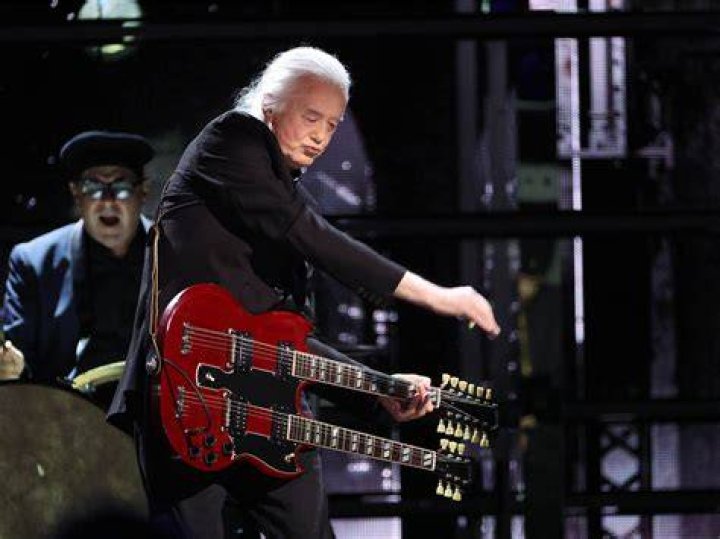 Jimmy Page playing guitar in concert Jimmy Page playing guitar in concert