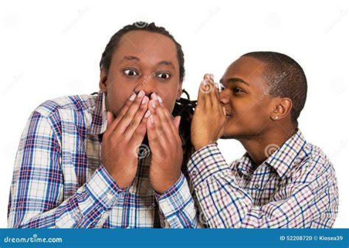Man whispering something funny into his lady's ear Man whispering something funny into his lady's ear