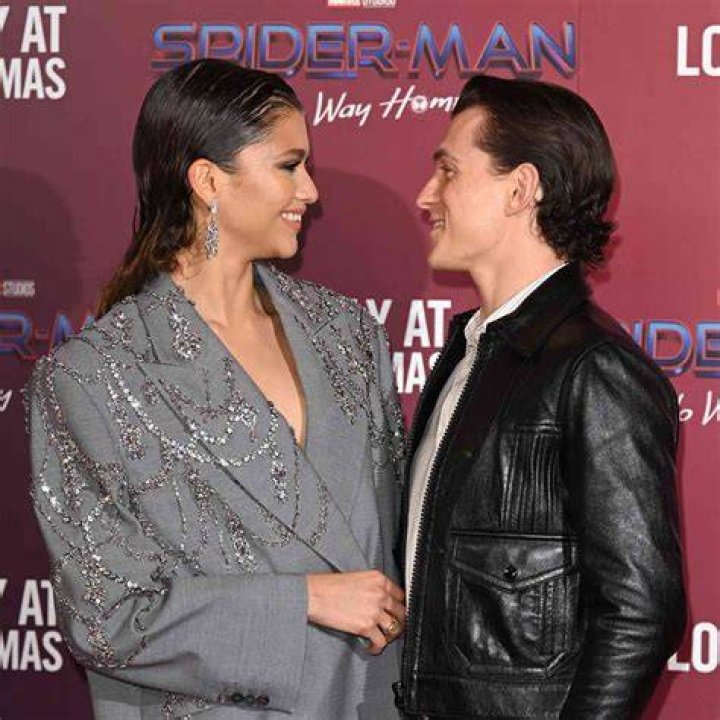 Zendaya and Tom Holland looking at each other during an interview.